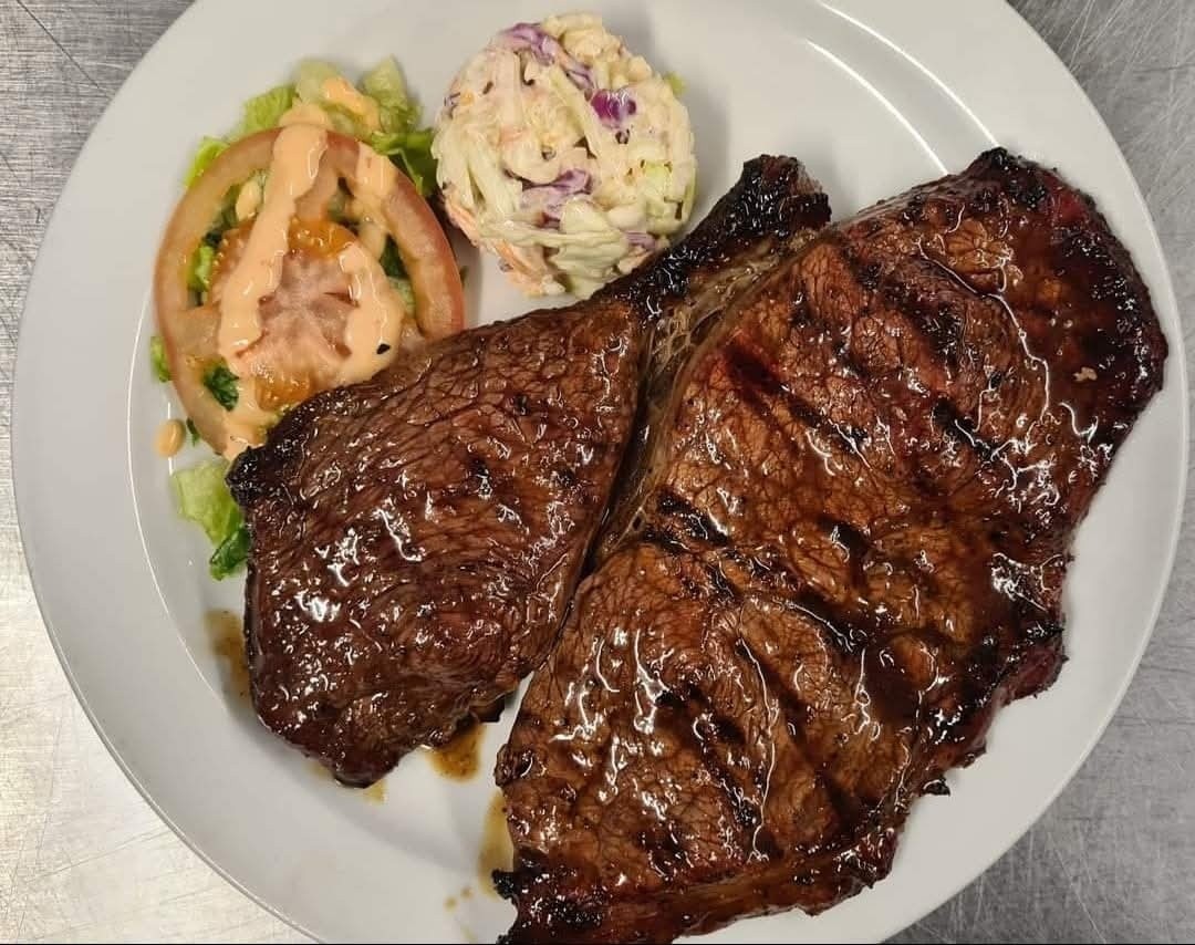 Sizzling hot steak on the grill
